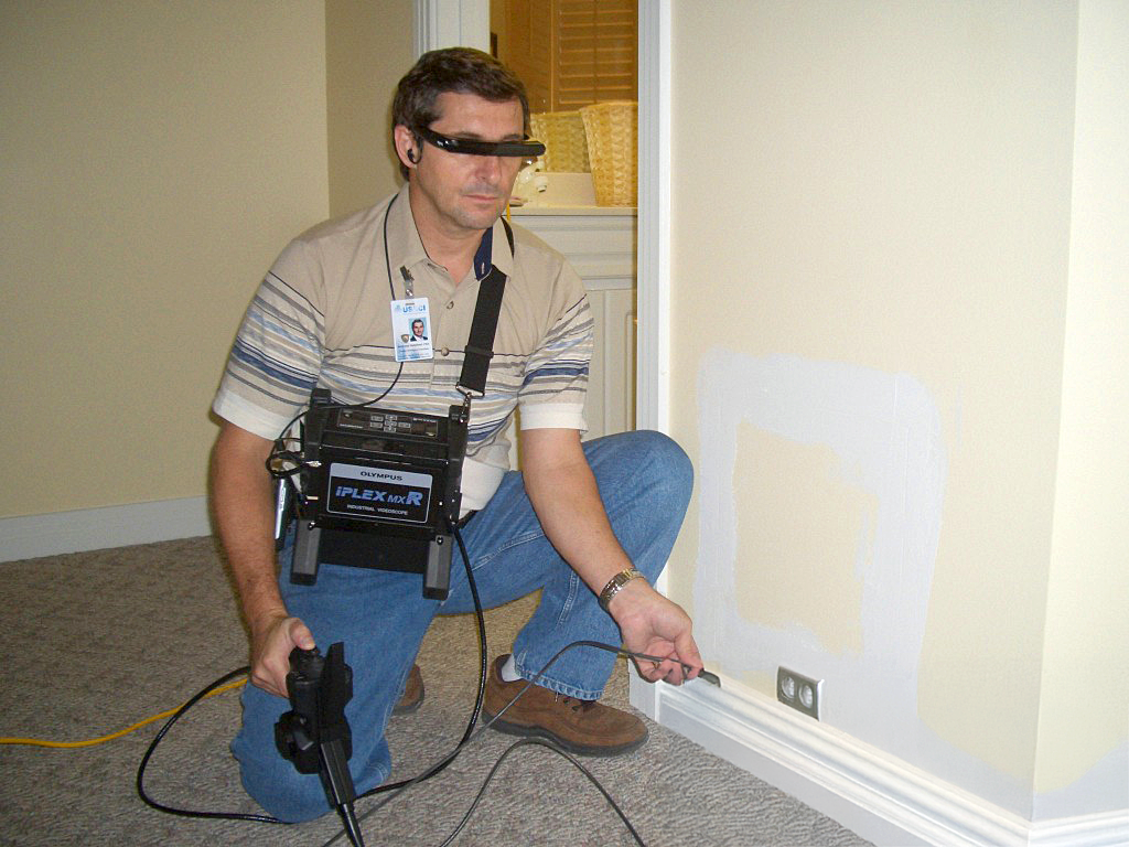 BMC Technician Uses A Fiber Optic Video Scope To Analyze Moisture And Water Intrusion In A Structure.